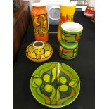 A selection of Poole pottery to include a green and blue decorated plate, five pieces in total.