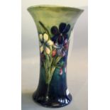 A Moorcroft vase with spring flowers in blue to green base, AF.