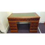 A Yew wood reproduction desk with green leather top.