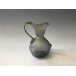 An Ancient Roman glass wine jug with handle and three berry decorations to side. Height 15cm. 15cm