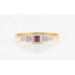 A ruby and diamond three stone ring, set with a central square cut ruby, flanked to either side with