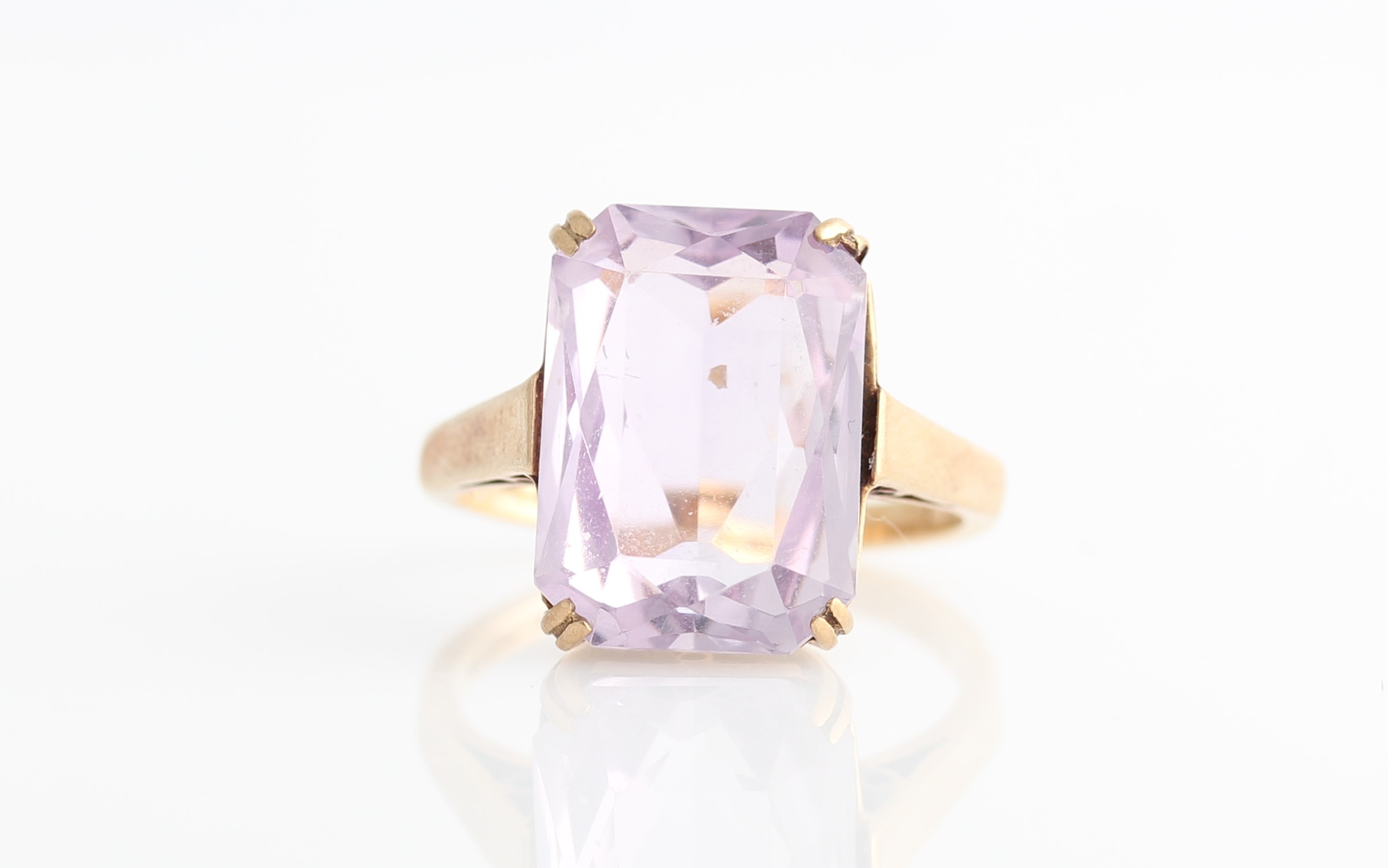 A hallmarked 9ct yellow gold amethyst dress ring, set with a princess cut amethyst, measuring