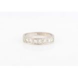 A hallmarked 18ct white gold diamond half eternity ring, set with seven round brilliant cut