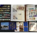 A collection of World stamps in folders, together with two boxes of coins to include mint and