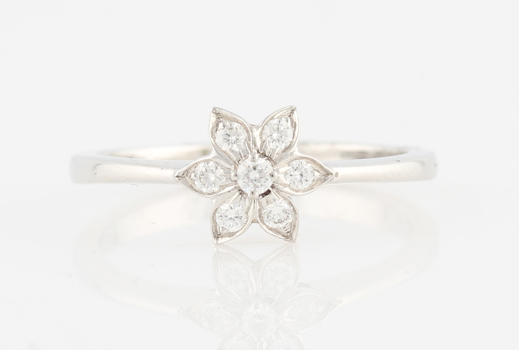 A diamond flower design cluster ring, set with round brilliant cut diamonds, hand engraved 18k, ring