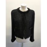A CHANEL black jacket with silver coloured woven thread throughout and silk lining