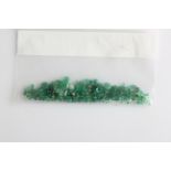 A collection of facetted emeralds, of various sizes and to include round cuts, oval cuts, cabochons,