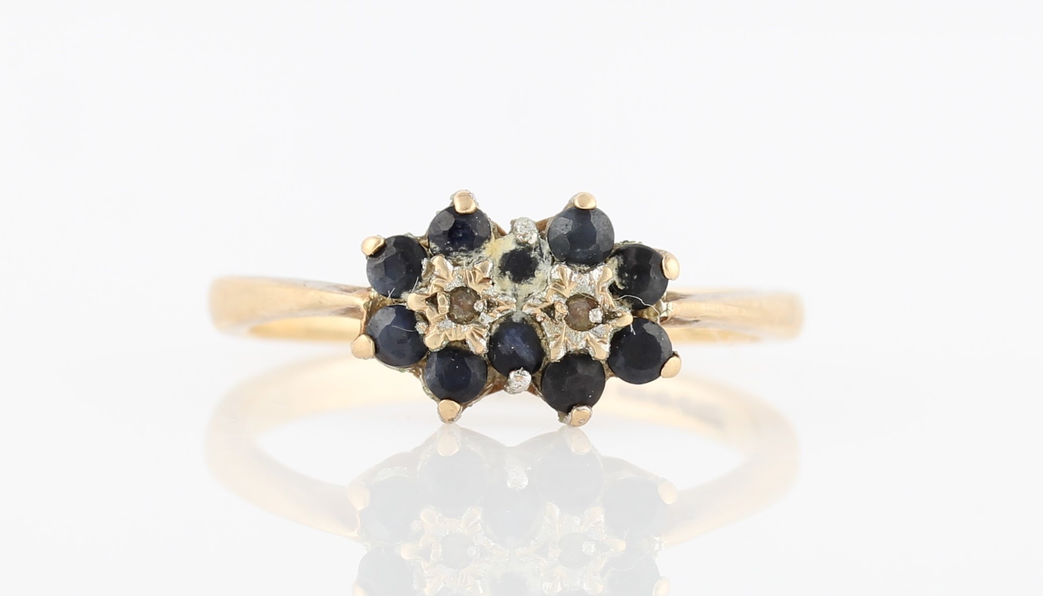 A hallmarked 9ct sapphire and diamond double cluster ring, ring size O.