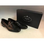 A pair of PRADA black leather men’s loafers in fabric bag and a PRADA box