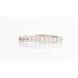 A hallmarked 18ct white gold diamond half eternity ring, set with eleven round brilliant cut