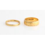 A hallmarked 22ct yellow gold engraved wedding band, together with a thinner wedding band,