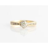 A hallmarked 18ct yellow gold diamond ring, set with principle round brilliant cut diamond,