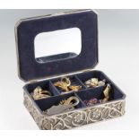 A large collection of brooches and a pendant and chain, housed in a white metal jewellery box.