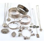 A collection of jewellery, to include a hallmarked silver engraved bangle, four bangles, stamped