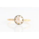 A pearl ring, set with a single pearl within an open metalwork design, stamped 18ct, ring size M½.