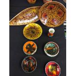 A selection of Poole pottery to include a shield shaped dish and a small vase. Eight pieces in