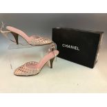 A pair of pink CHANEL kitten healed shoes with strap design, in box.