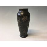 A bronze vase with bird and flower design, height 15cm.