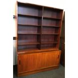 A Danish mid 20th Century Poul Hundevad rosewood double bookshelf with two door cupboard base.