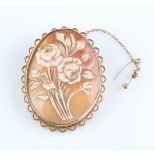 A hallmarked 9ct yellow gold framed cameo brooch, featuring floral design.