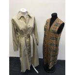 A Burberry’s ladies long brown trench coat with belt and sleeveless cardigan set.