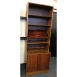 A Poul Hundevad single bookshelf with single door cupboard base.
