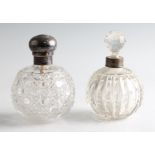 Two silver collared glass perfume bottles, one collar hallmarked London 1900 (rubbed), the other