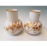 A Royal Worcester pair of bulbous based vases with red and gilded bamboo and leaf design with