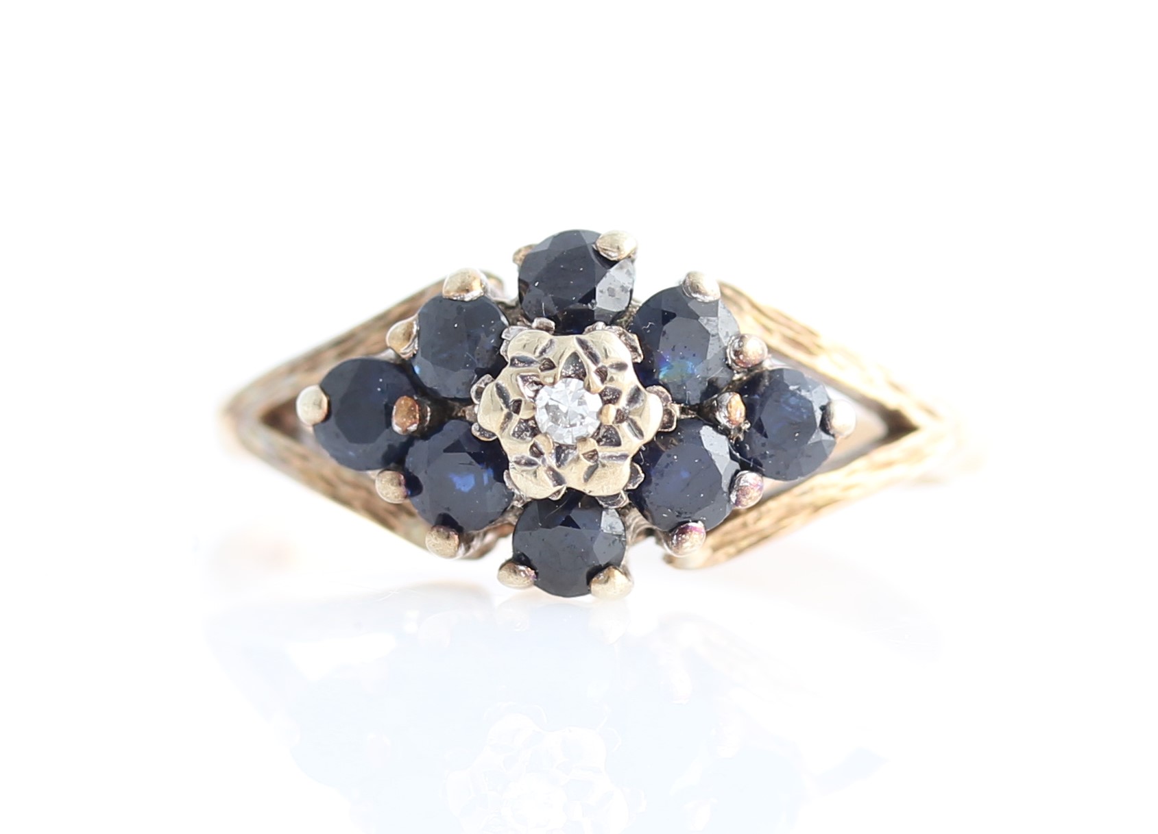 A hallmarked 9ct yellow gold sapphire and diamond cluster ring, set with a central eight-cut diamond
