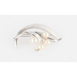 A Mikimoto pearl brooch, set with four variously sized pearls, smallest measuring approx. 5mm and