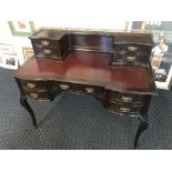 An Edwardian mahogany ladies two tired writing desk with red leather interior, fitted with nine