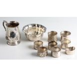 A collection of hallmarked silverware, to include a tankard, a fluted dish, five napkin rings, one