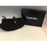 A CHANEL black clutch with stitched flower and diamond design and metal and leather strap in box