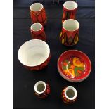 A group of red and orange Poole pottery to include vases and bowls. Eight pieces in total.