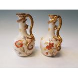 A pair of Royal Worcester gilded dragon handle water jugs with floral design, puce mark to base