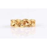 An open metalwork plait design ring, hallmark indistinct, additionally stamped 750, ring size P½.