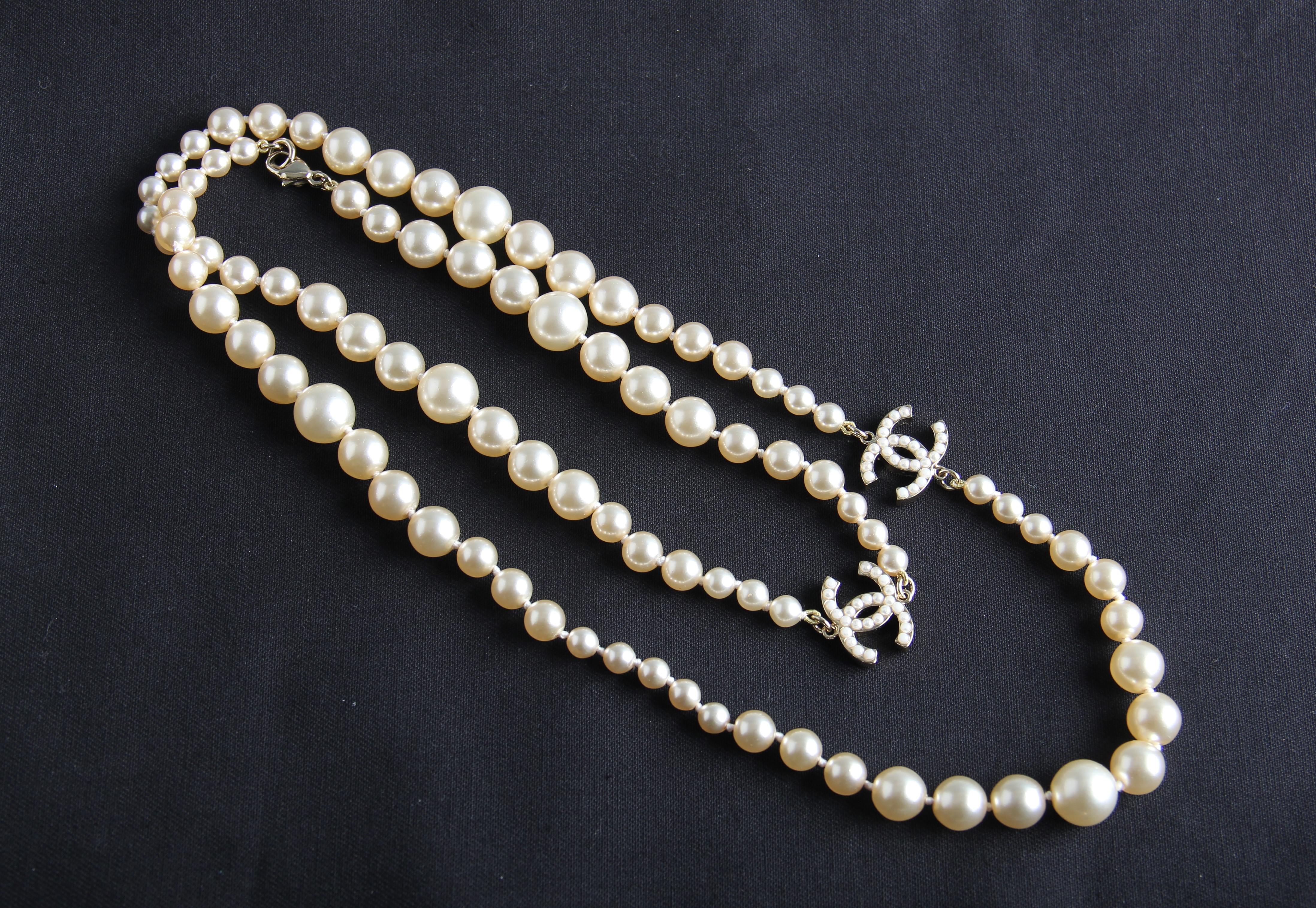 A 2006 Chanel opera length graduated simulated pearl necklet with interlocking ‘C’ logos, clasp