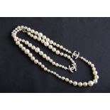A 2006 Chanel opera length graduated simulated pearl necklet with interlocking ‘C’ logos, clasp
