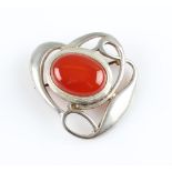 A Liberty & Co. silver carnelian brooch, the open metalwork Arts & Crafts design set centrally