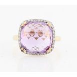 A hallmarked 9ct yellow gold amethyst and diamond dress ring, set with a central cushion rose cut