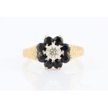 A hallmarked 9ct yellow gold sapphire and diamond cluster ring, set with a central eight-cut diamond