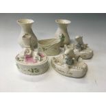 A selection of Belleek items to include two salmon leaping, a Millennium pot and lid with baby