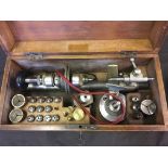 A watch makers lathe in wooden box.