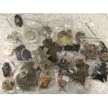 A quantity of cap badges, pins and buttons.