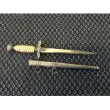 A German style officers dagger with stamp to blade in metal scabbard.