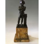 A bronze of Napoleon standing with arm crossed on sienna marble base, total height 29cm.