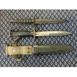 A commando knife together with American dagger with scabbard.