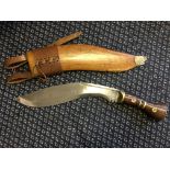 A 1917 Khukuri with stamp to blade, mahogany and brass handle and leather and wood scabbard with