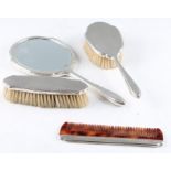 A matched Walker & Hall silver dressing table set, comprising a hair brush, a hand brush, a mirror