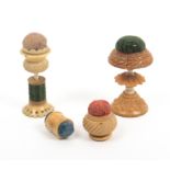 Four vegetable ivory pin cushions comprising a standing example with reel stem, 7cm, another